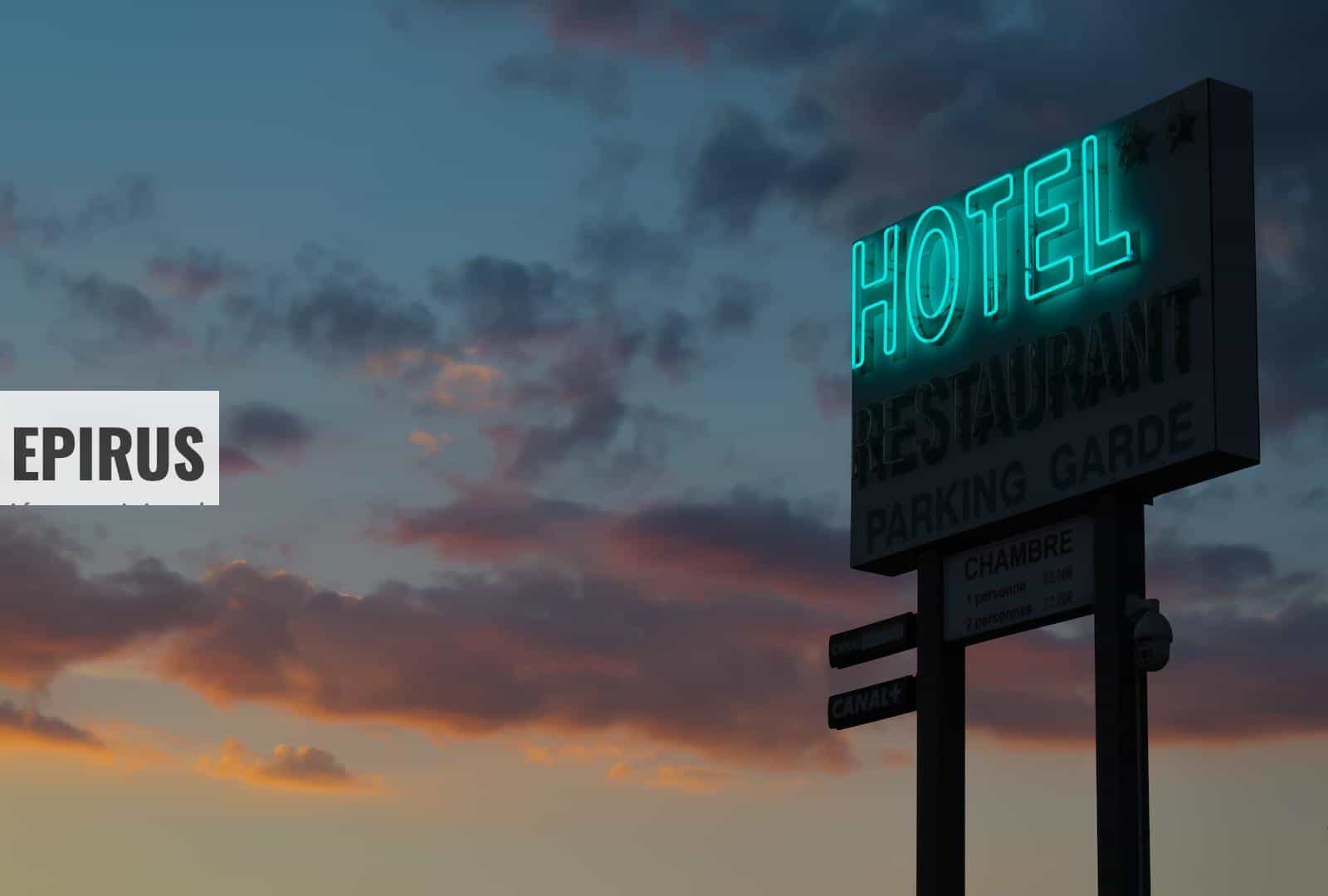 turned-on green hotel LED light signage ahead