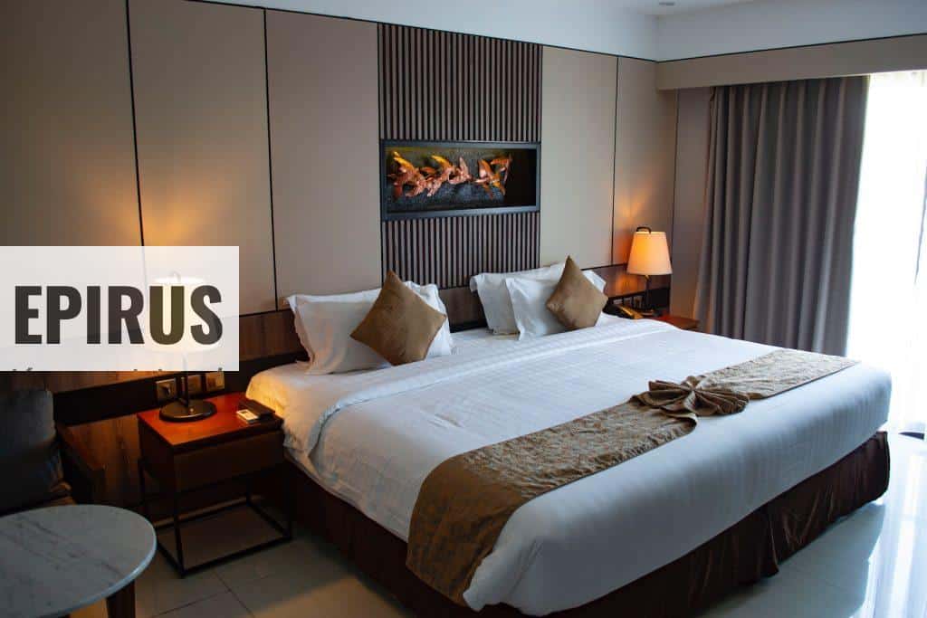 white bed linen with throw pillows