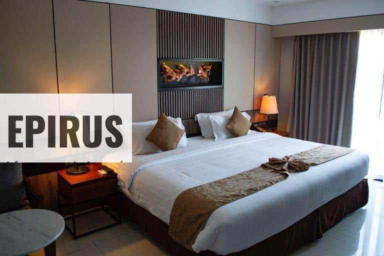 white bed linen with throw pillows