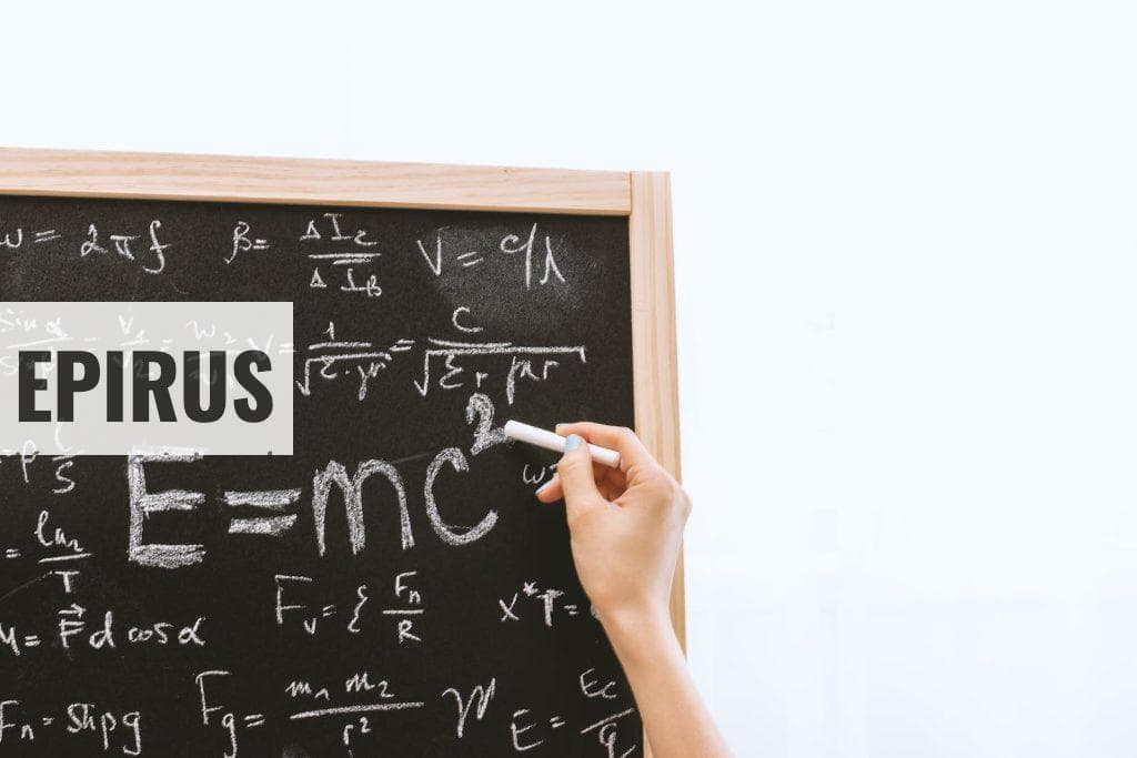 Person Holding a Chalk in Front of the Chalk Board