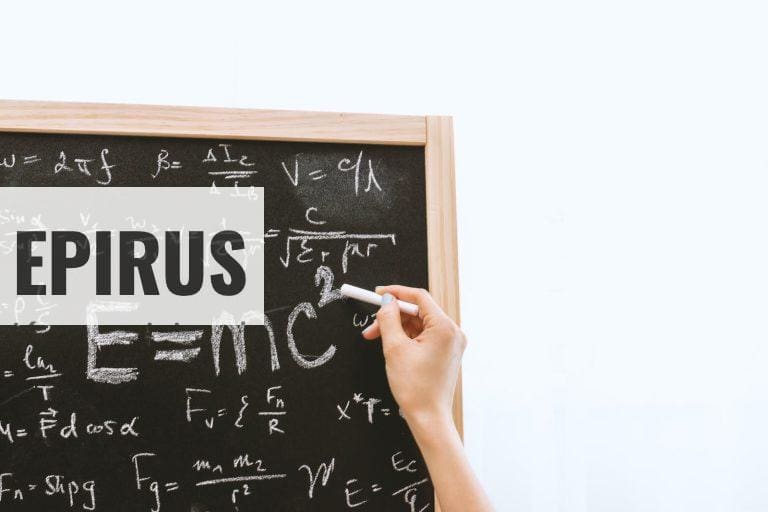 Person Holding a Chalk in Front of the Chalk Board