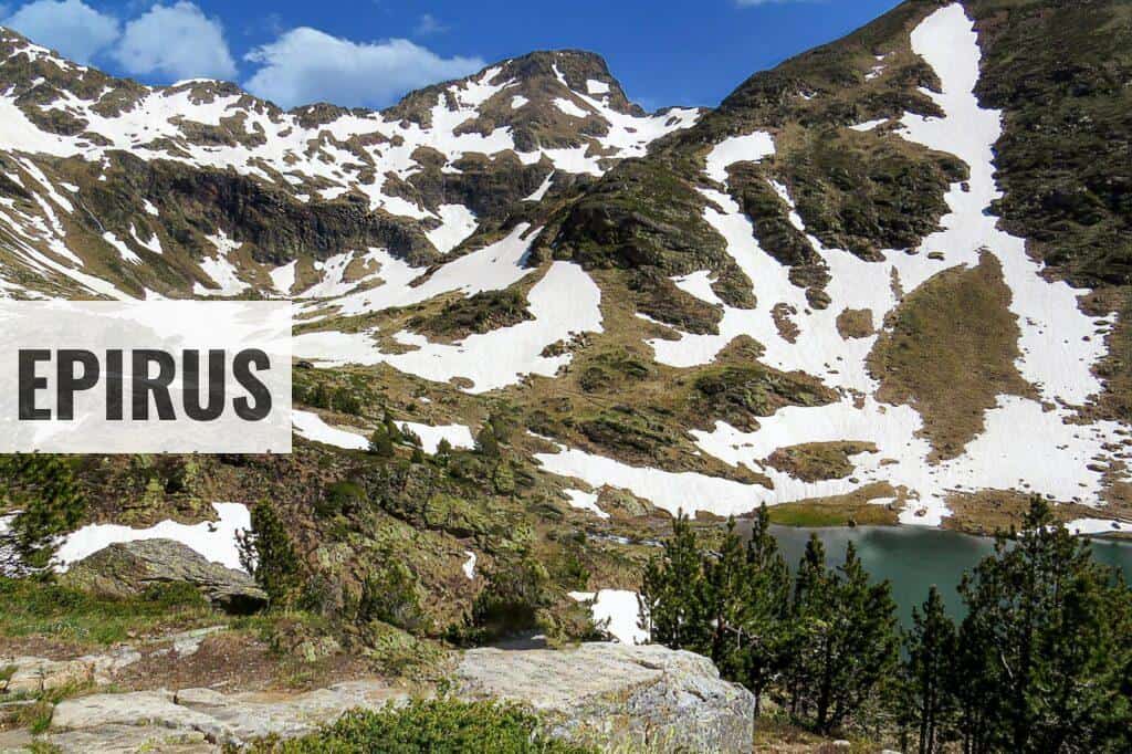 snow covered mountain near body of water during daytime