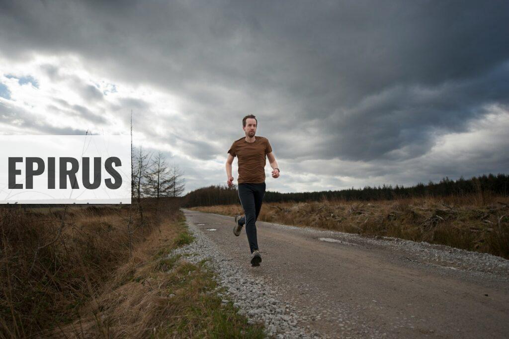 man running at the road during daytime
