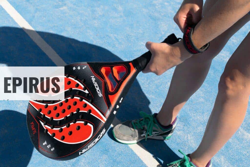 a close up of a person holding a tennis racket