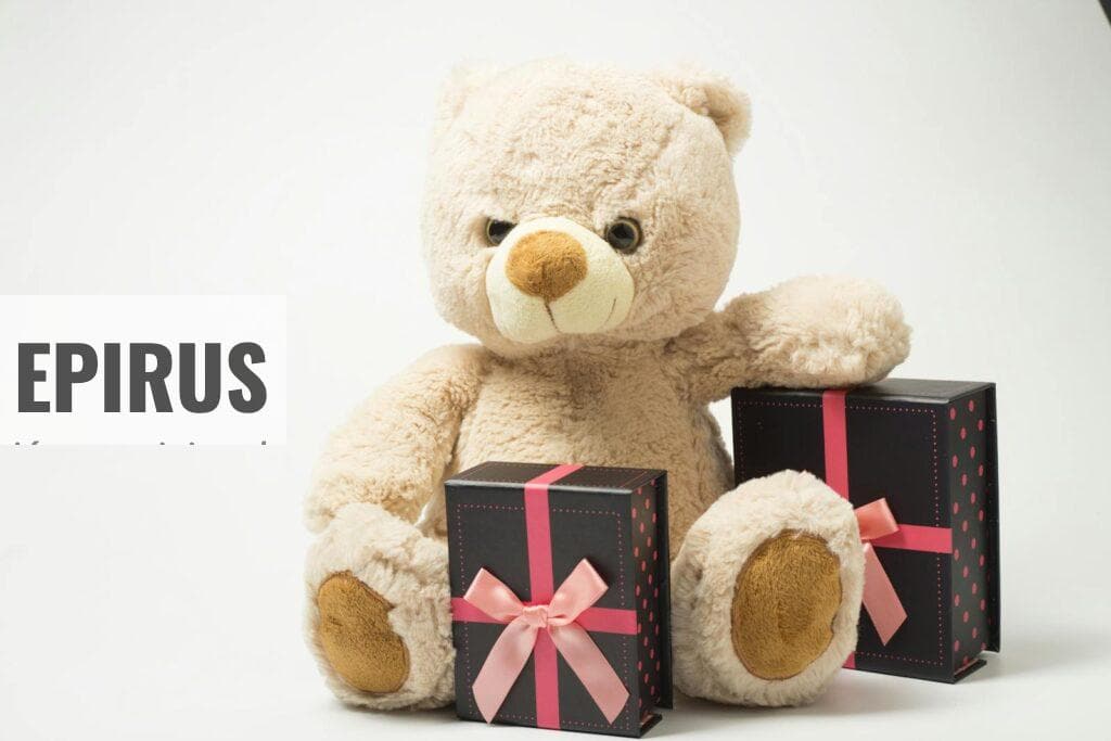 Adorable teddy bear with gift boxes tied with pink ribbons, perfect for celebrations.