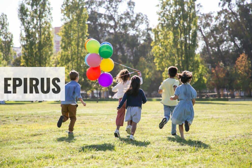 Children happily running with balloons in a sunny park, capturing friendship and joy.