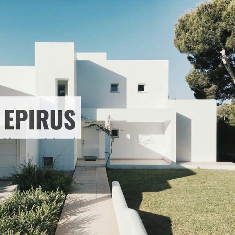 white concrete house near green tree during daytime
