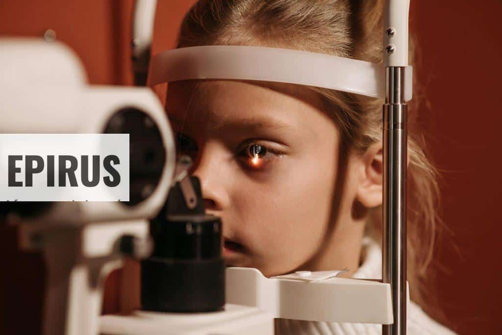 A young girl undergoing an eye exam with advanced ophthalmology equipment, focusing on vision care.