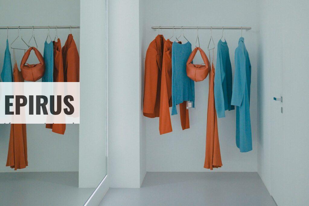 A room that has a bunch of clothes hanging on a rack